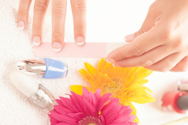 Woman with well manicured nails on white