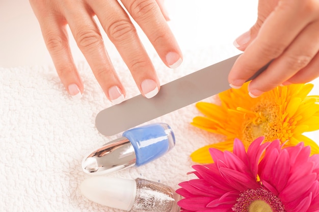 Photo woman with well manicured nails on white