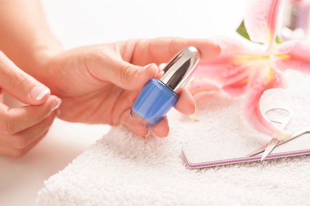 Woman with well manicured nails on white