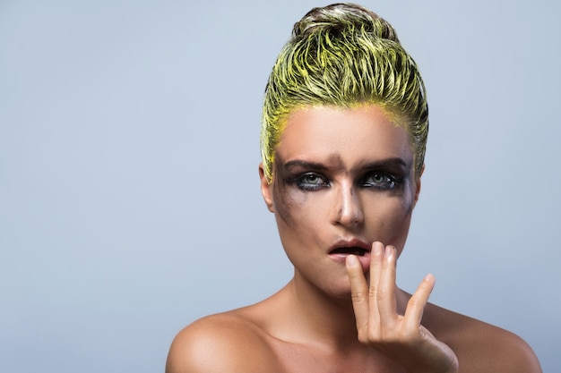 Woman with wet eyeshadows and yellow hair