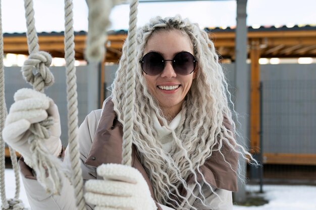 Photo woman with white dreadlocks swinging