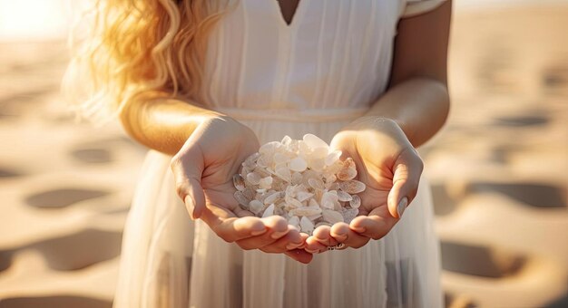 woman with white hair is holding onto sand on the beach in the style of traditional essence