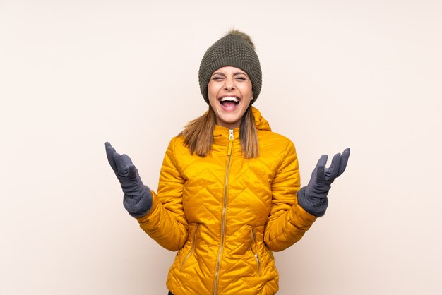 Woman with winter hat over wall unhappy and frustrated with something