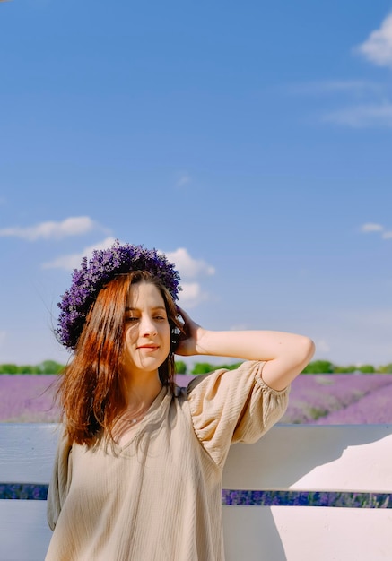 Woman with wreath of flowers in lavender field