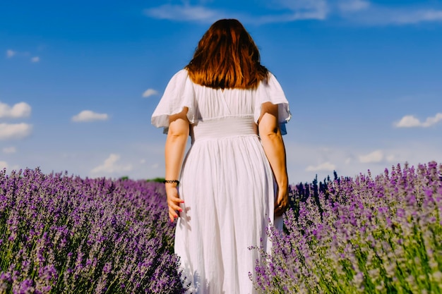 Woman with wreath of flowers in lavender field