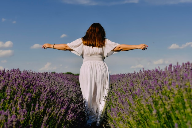 Woman with wreath of flowers in lavender field