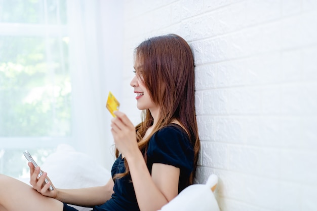 Woman with a yellow credit card in his hand