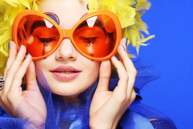 Woman with yellow  hair and carnaval glasses