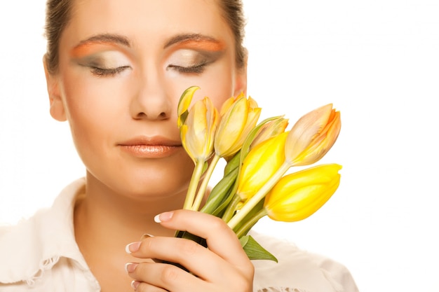 Woman with yellow tulips  over white