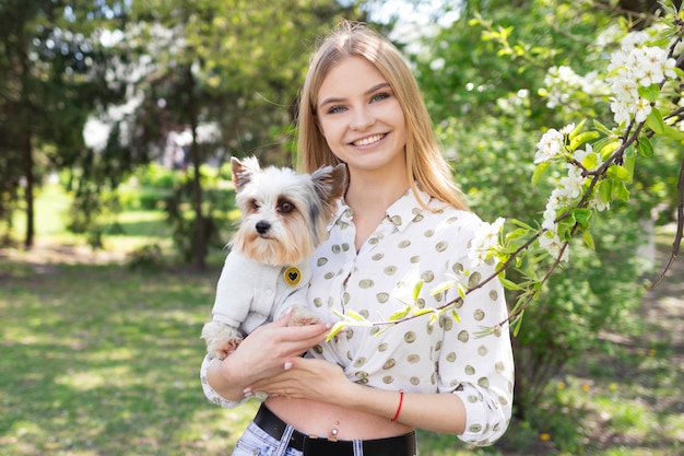 A woman with a Yorkshire terrier, love for pets