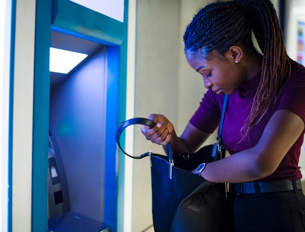 Woman withdrawing money from a cash machine