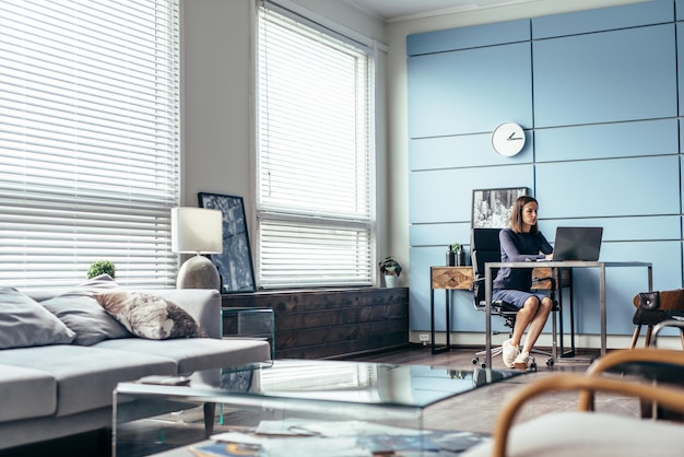 Woman at work sits and works with a notebook