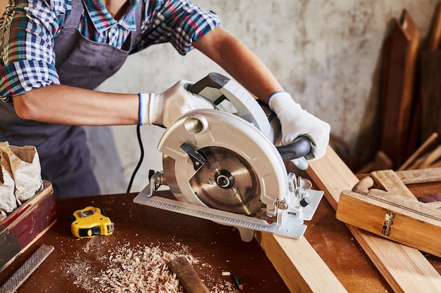 Woman worker in the carpenter workroom renovation