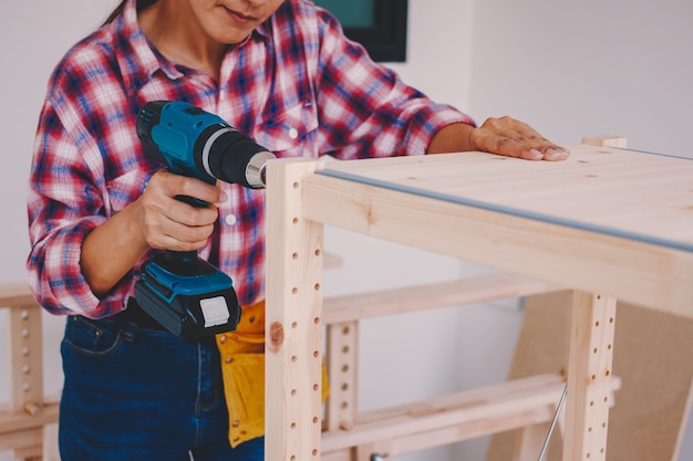 Woman worker in the carpenter workroom.