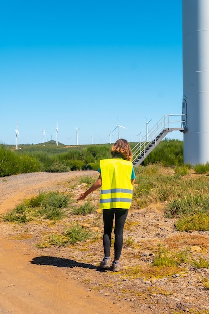 A woman worker in a wind farm green energy technical review making a call