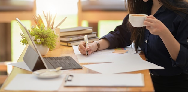 Woman worker working with paper works and laptop