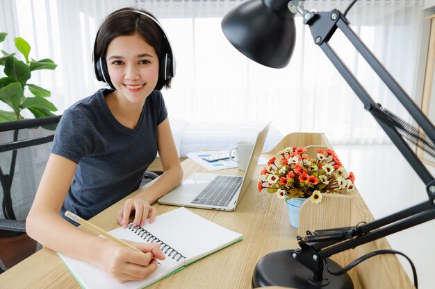 Woman working in bedroom and smile