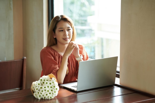 Woman Working at Coffeeshop Table