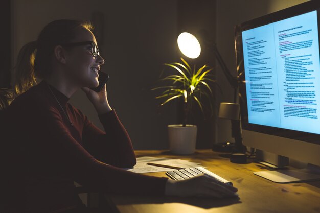 Woman working at computer at home office