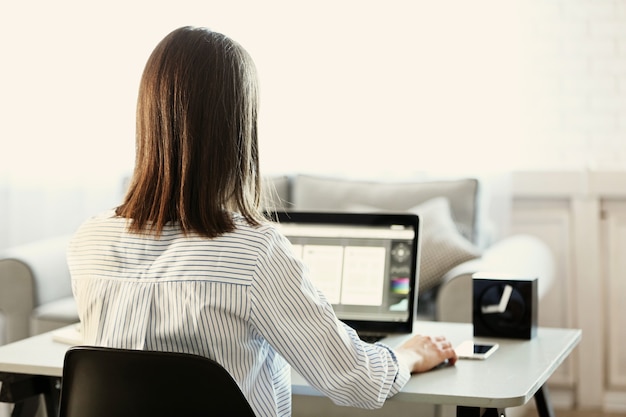 Woman working on computer at home