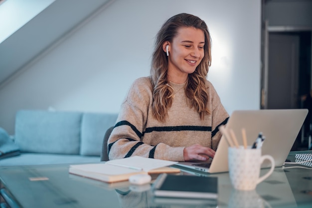 Woman working from a home on her a laptop