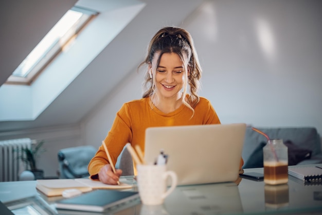 Woman working from a home on her a laptop