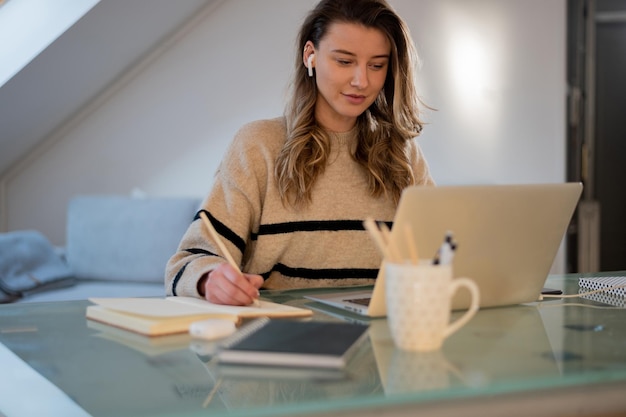 Woman working from a home on her a laptop