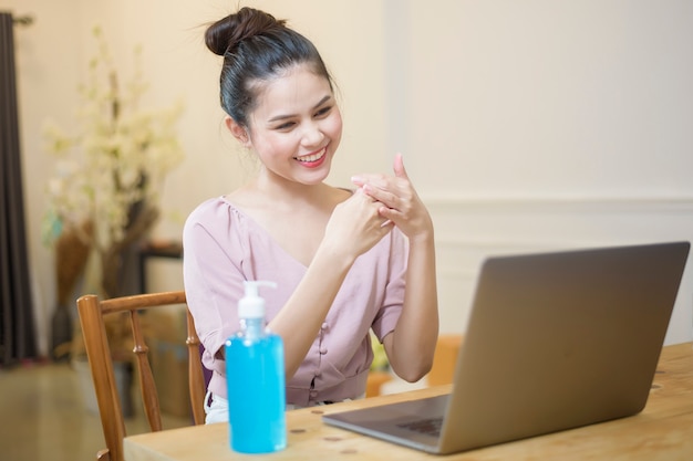 Woman working from home with Alcohol gel