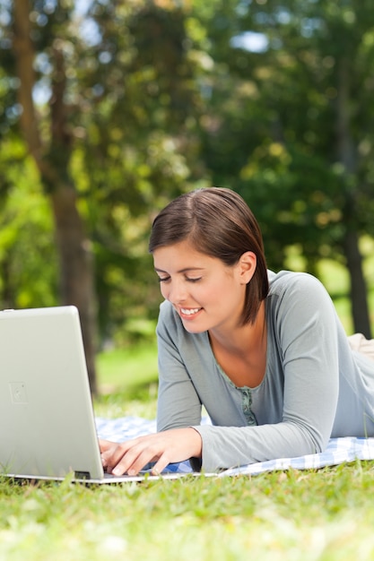 Woman working on her laptop in the park