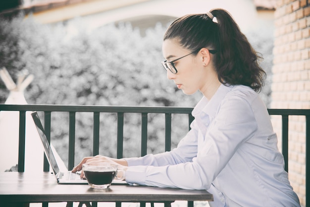 Woman working at home office hand on laptop