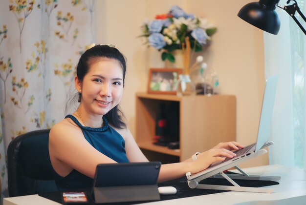 Woman working on a laptop in her home