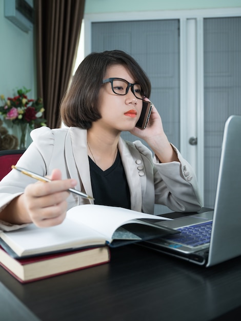 Woman working on laptop in home office