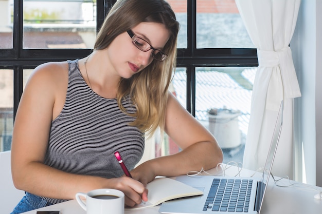 Woman working on laptop at home.