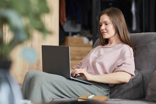 Woman working on laptop online