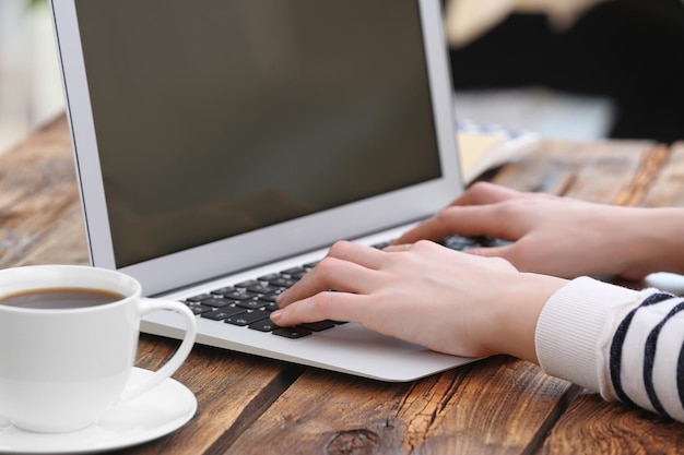 Woman working on laptop at table