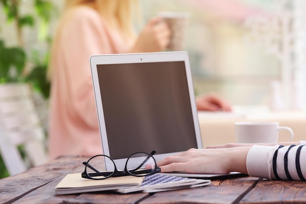 Woman working on laptop at table