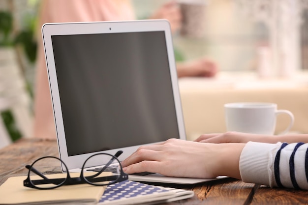 Woman working on laptop at table