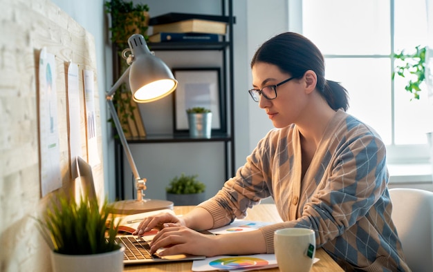 Woman working on a laptop.