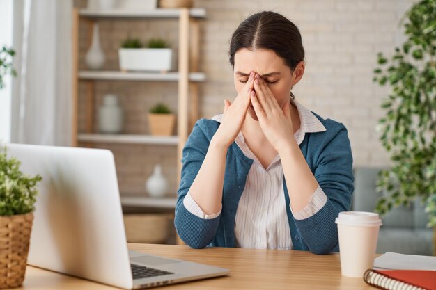 Woman working on a laptop.