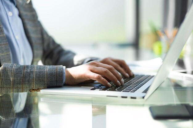 Woman working at office Hand on keyboard Close up