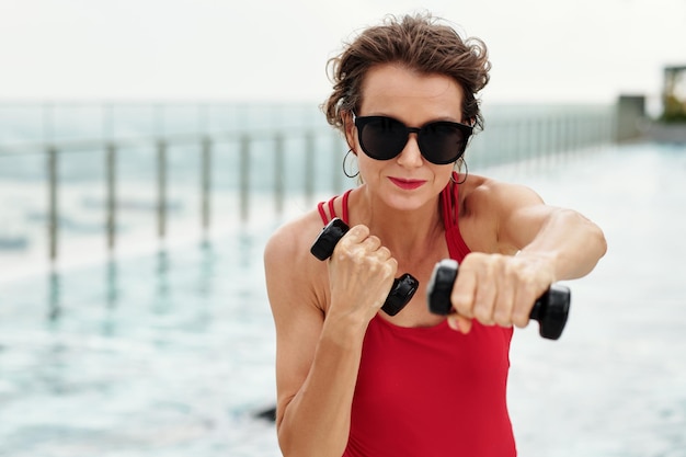 Woman Working out by Swimming Pool