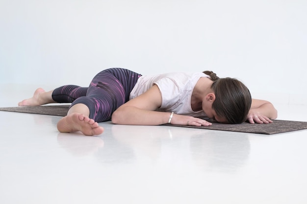 Woman working out doing yoga or pilates exercise stretching her legs