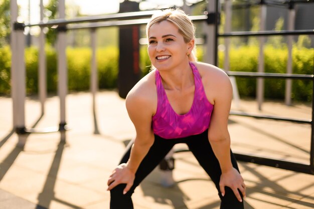 woman working out in gym on equipment outdoors having fun