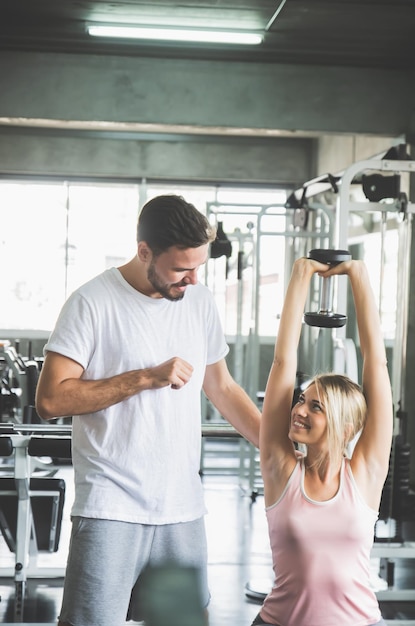 Woman working out in sport fitness centerCouple workout at Gym