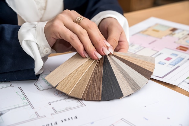 Woman working with color palette with house plan