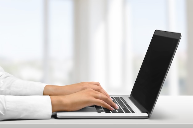 Woman Working with Laptop on background, close-up