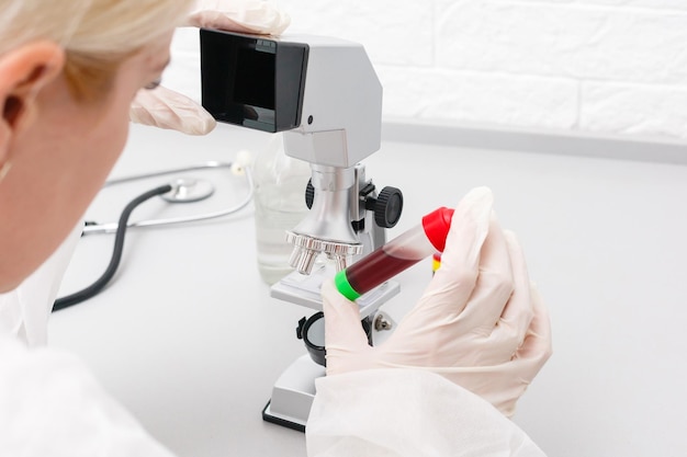 Woman working with a microscope in lab