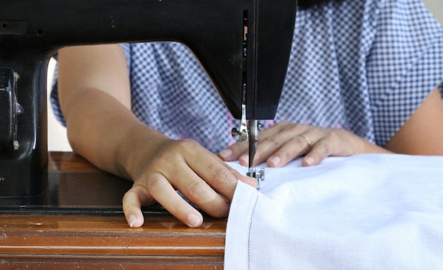 Woman working with sewing machine.