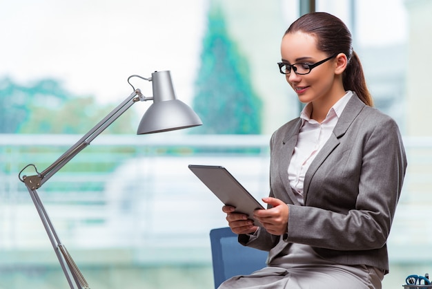 Woman working with tablet in office