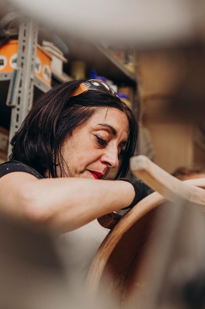 Woman working wood in workshop